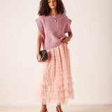 Ladies' travel-ready rose pink oversized knit sweater vest layered over a tiered ruffle maxi skirt.