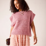 Rose pink knit sweater vest with a wide ribbed hem and draped sleeves.