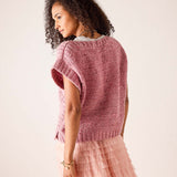 Rose pink chunky knit sweater vest with a textured ribbed knit and short cap sleeves.