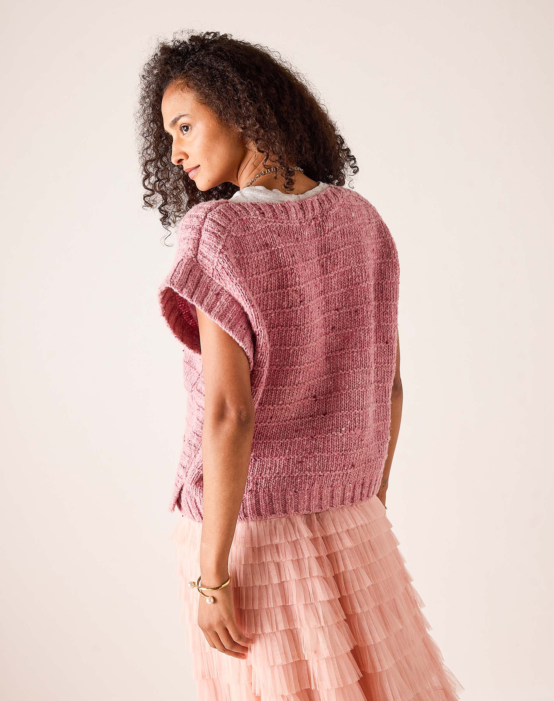 Rose pink chunky knit sweater vest with a textured ribbed knit and short cap sleeves.