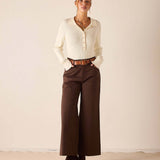 Women's travel-friendly creme ribbed knit long sleeve polo shirt with button placket.