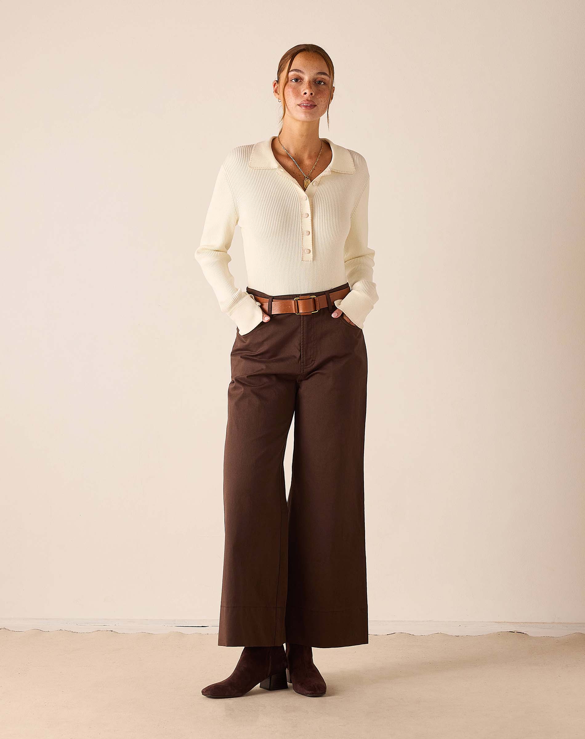 Women's travel-friendly creme ribbed knit long sleeve polo shirt with button placket.
