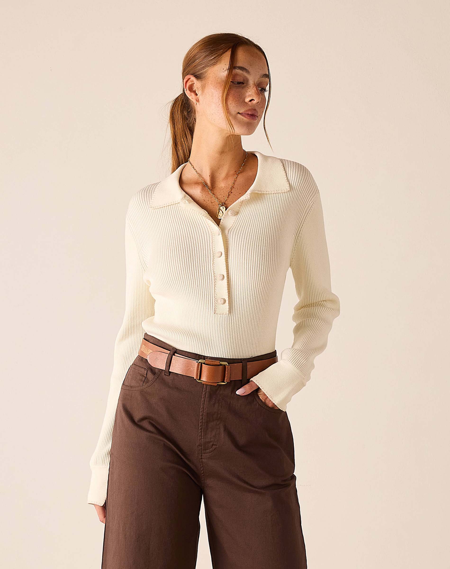 Creme ribbed long-sleeved polo top with button detail.