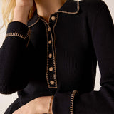 Ink black ribbed knit long sleeve polo with decorative stitching and button accents