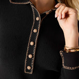 Ink black ribbed knit long sleeve polo with decorative contrast stitching and buttons.