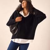 Women's travel-friendly black cashmere v-neck oversized sweater with a wide ribbed hem and drop shoulders.