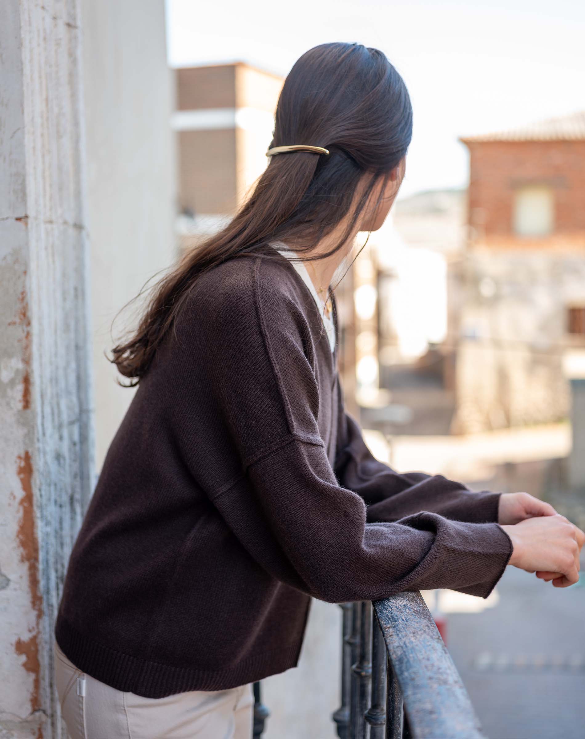 Truffle colored knit v-neck sweater with dropped shoulders and wide ribbed cuffs.