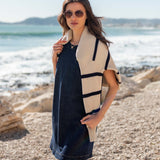 Midnight blue denim dress with a layered cream and black striped knit wrap
