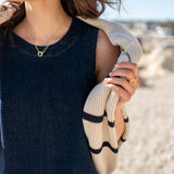 Midnight navy denim-texture dress with a textured knit wrap featuring striped patterns.