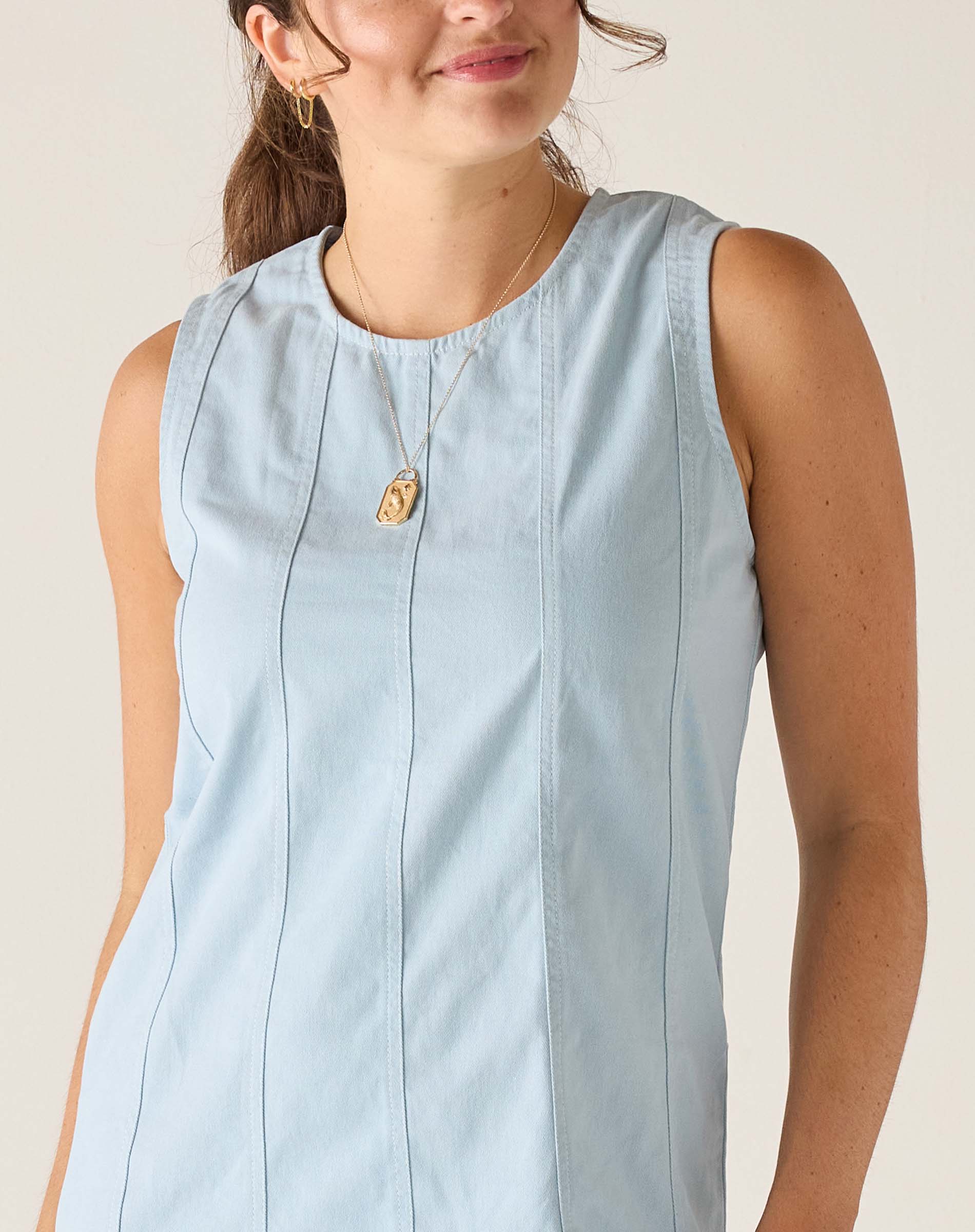 Clearwater blue twill dress with a sleeveless design and vertical stitching details.