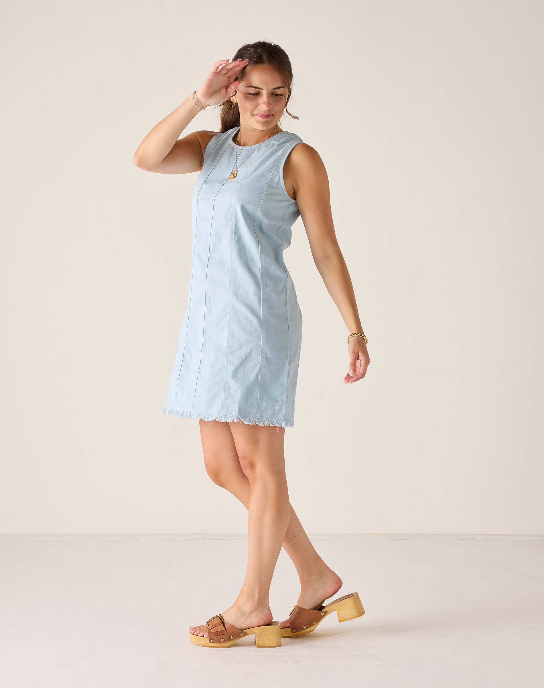 Clearwater blue twill dress with a sleeveless design and frayed hem.
