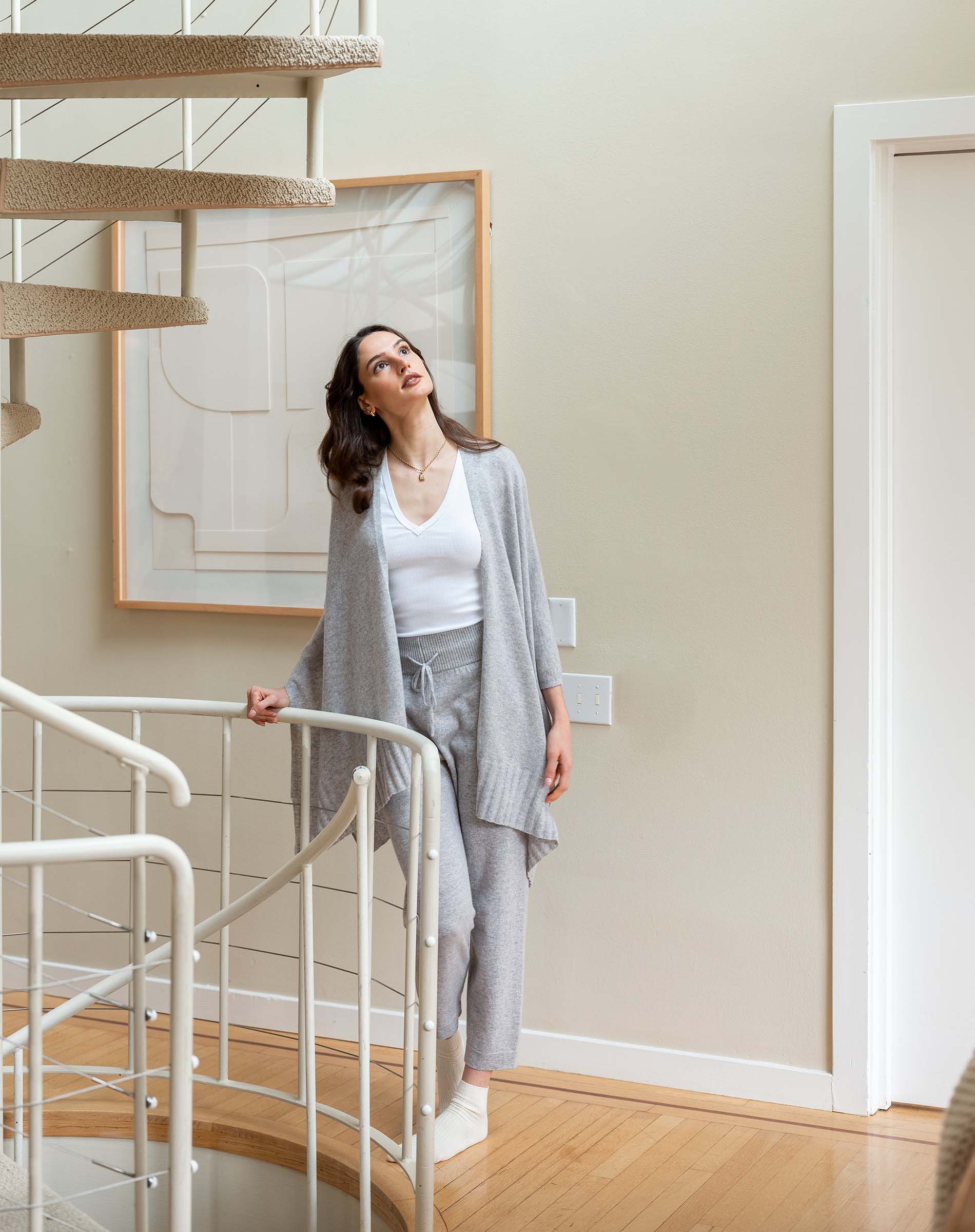 Woman standing on a staircase in a home interior