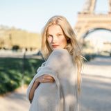 woman wearing mersea luxy wrap in cream standing in front of Eifel tower