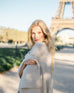 woman wearing mersea luxy wrap in cream standing in front of Eifel tower