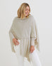 woman wearing mersea cashmere luxy wrap in neutral turtledove color wrapped around torso