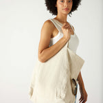 profile of woman with mersea oversized canvas tote in neutral flax over shoulder