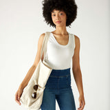 woman with mersea oversized canvas tote in neutral flax over shoulder