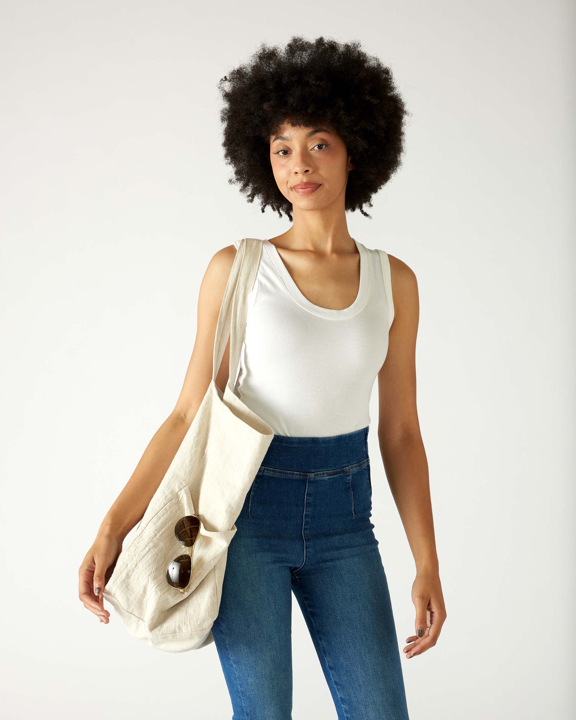woman with mersea oversized canvas tote in neutral flax over shoulder