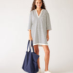 woman in striped dress carrying mersea oversized canvas tote in navy blue