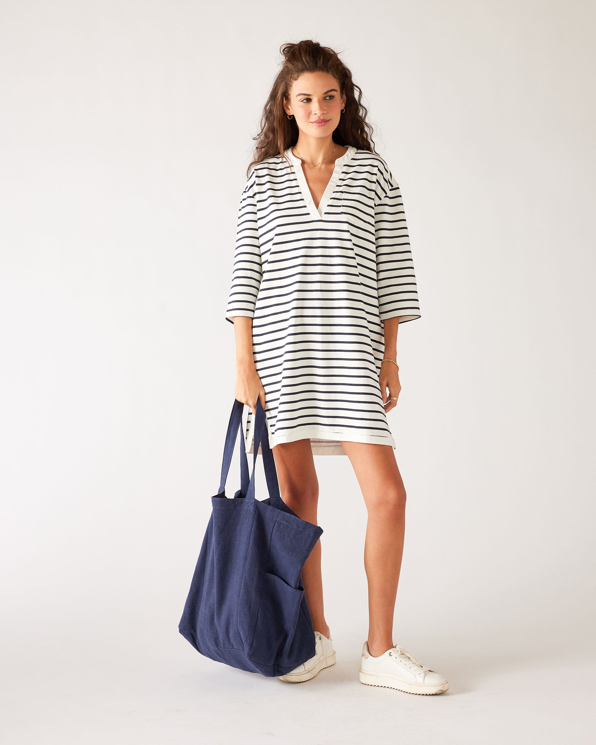 woman in striped dress carrying mersea oversized canvas tote in navy blue