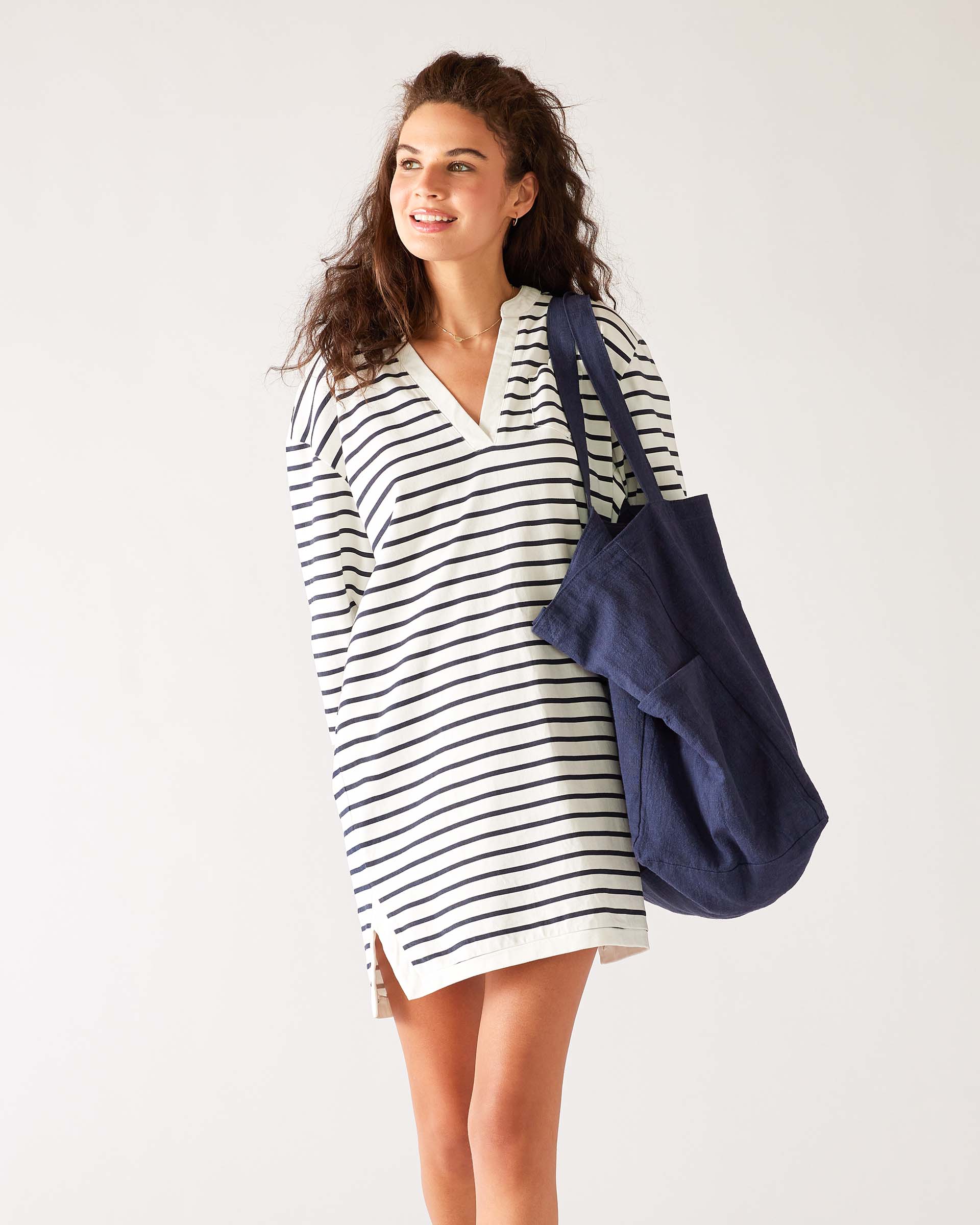 woman with mersea oversized canvas tote in navy blue over left shoulder