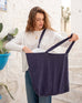 woman with mersea oversized canvas tote in navy blue looking inside tote