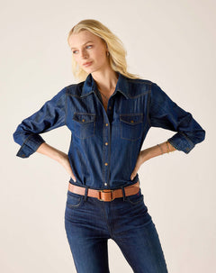 Night rain blue button-up shirt with breast pockets and rolled sleeves paired with denim jeans.