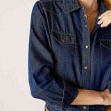 Navy blue button-up shirt with a pointed collar and chest pockets.