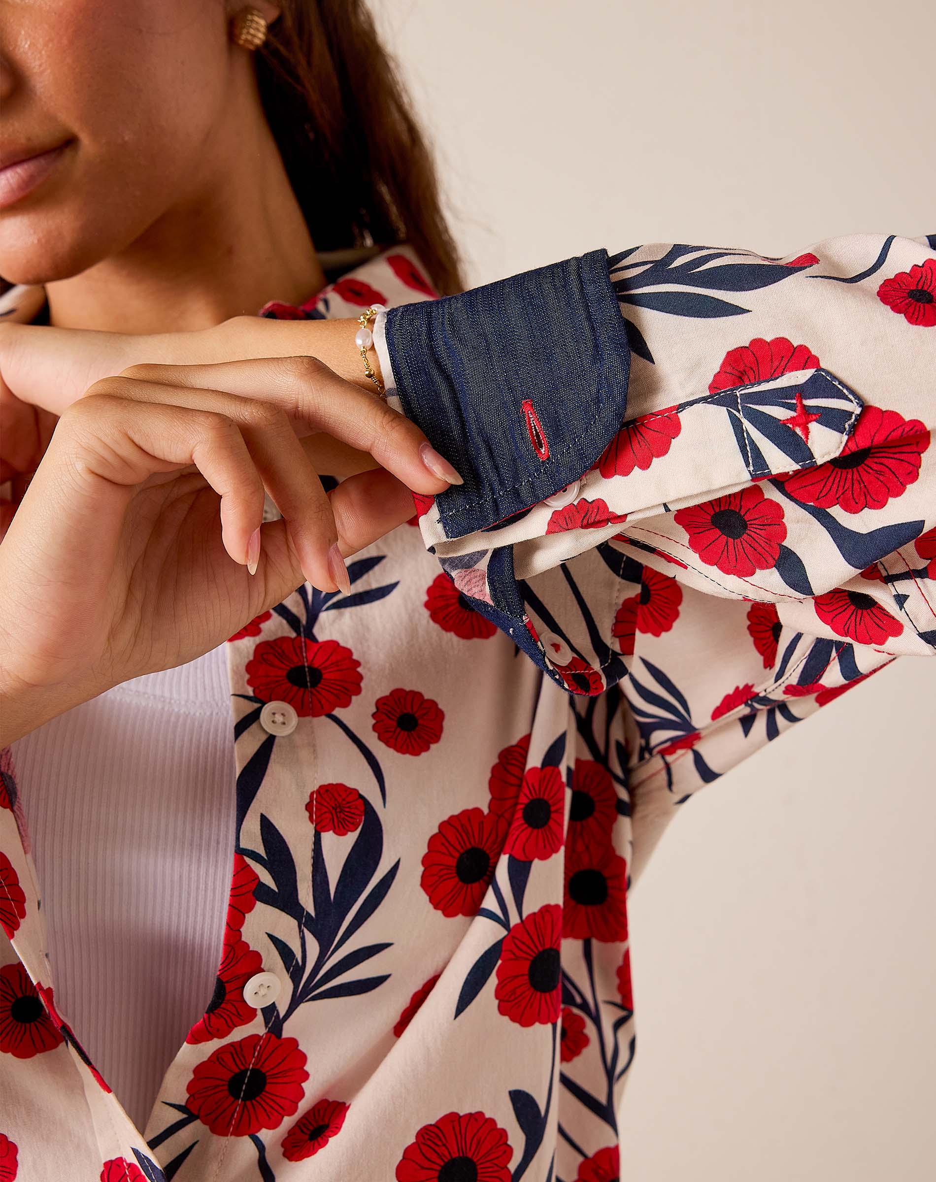 Poppy floral button-up shirt in red and navy blue with a contrast navy fabric pocket detail.