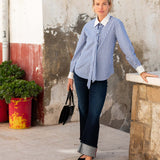 Women's travel-friendly blue double stripe button-up shirt with a white collar and tie detail.