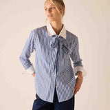 Light blue and white striped button-up shirt with a contrasting white collar and pussy-bow tie detail.