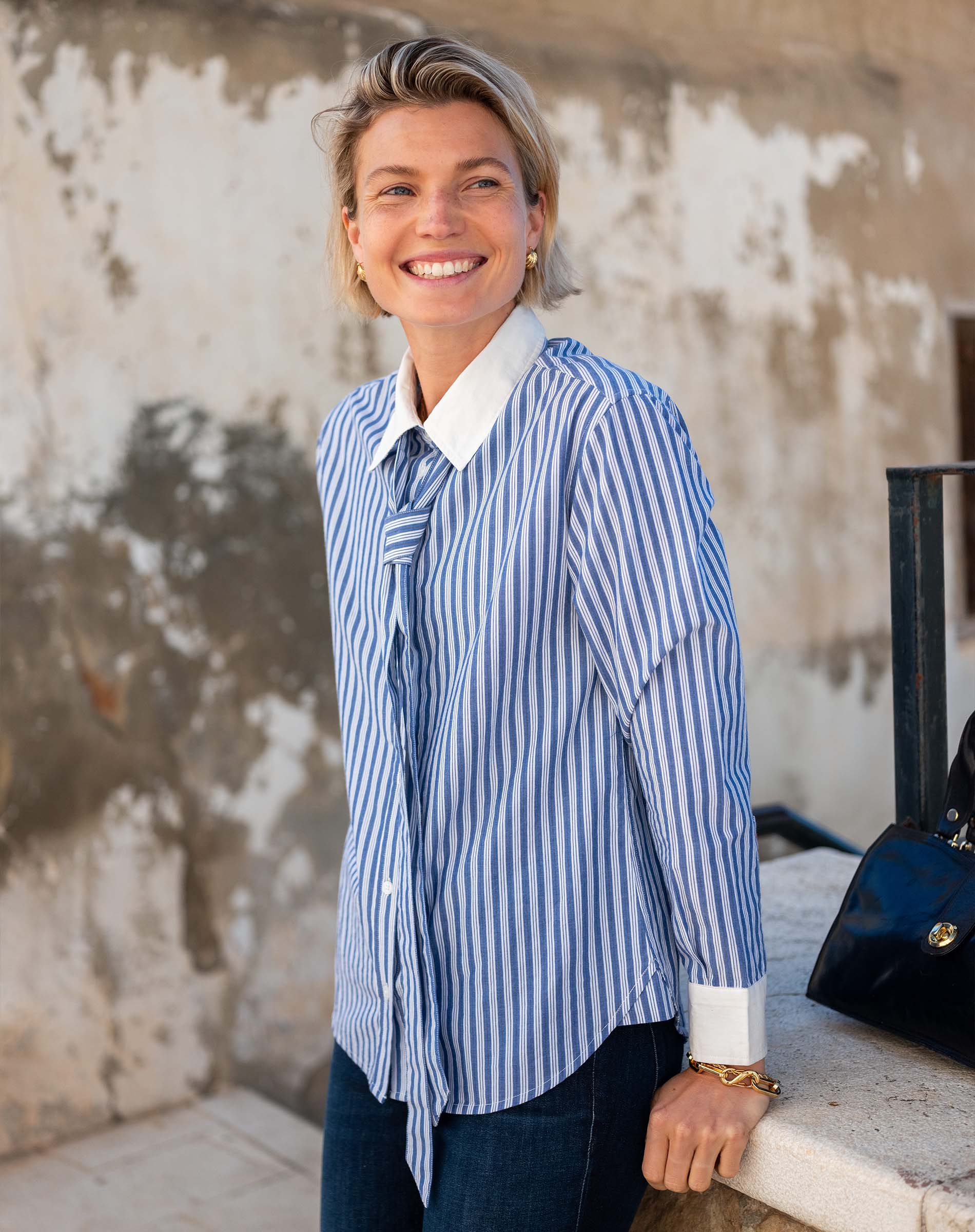 Blue and white double striped button-up shirt with a matching tie detail.