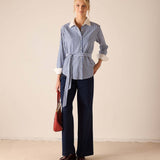 Blue double stripe button-up shirt with a white collar and wide sleeves.