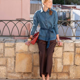 Women's travel-friendly blue button-up chambray shirt with a matching waist tie.