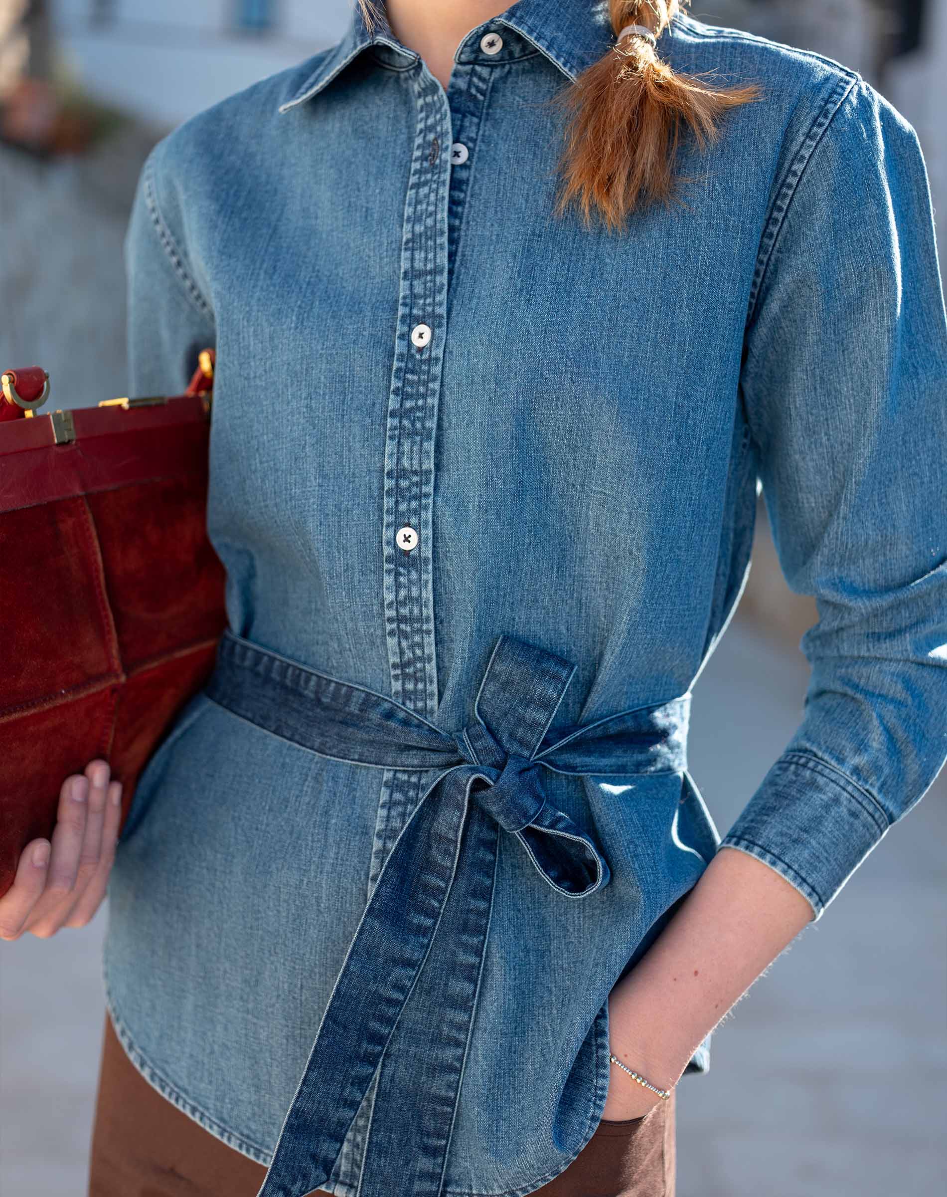 Medium blue button-up chambray shirt with a waist tie detail.