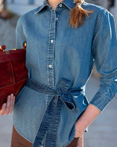 Medium blue button-up chambray shirt with a waist tie detail.