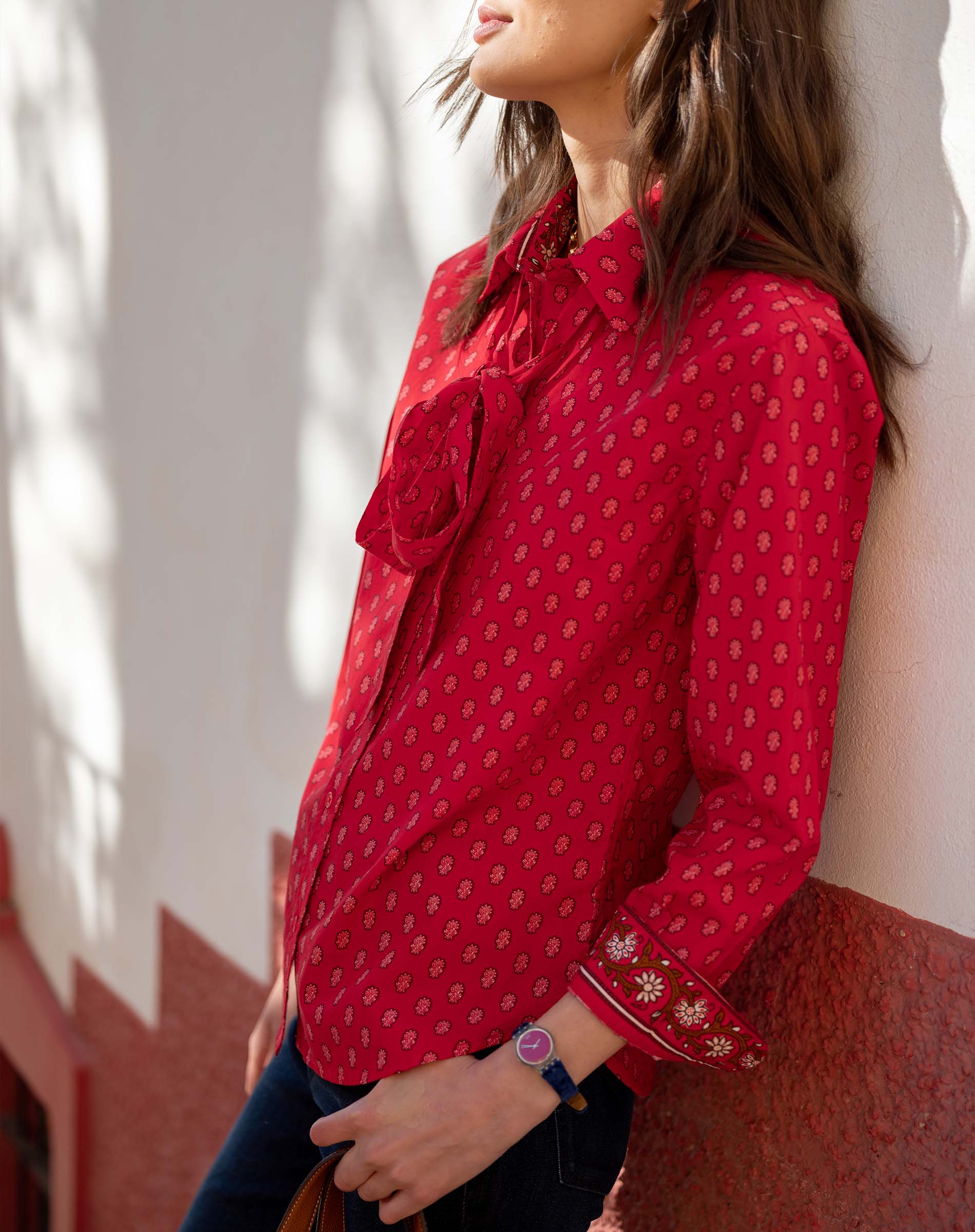 Crimson red button-up shirt with small geometric patterns and tie details on the front.