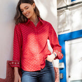 Crimson button-up shirt with a small geometric pattern and scalloped edges.