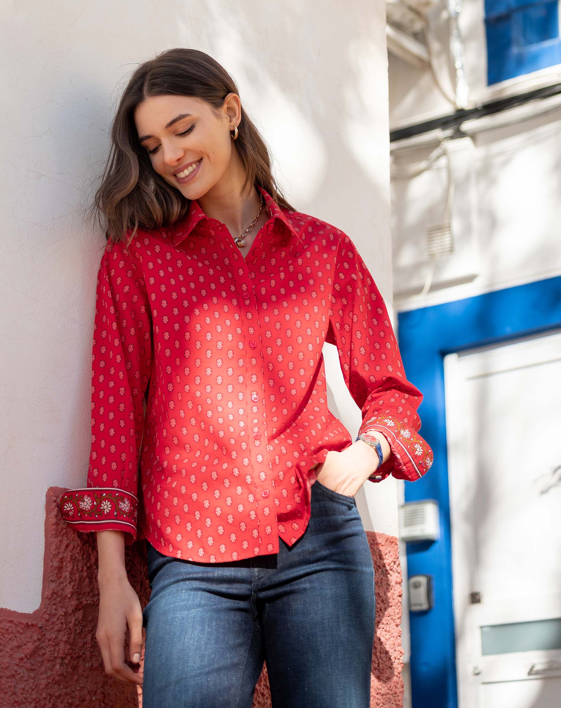 Crimson button-up shirt with a small geometric pattern and scalloped edges.