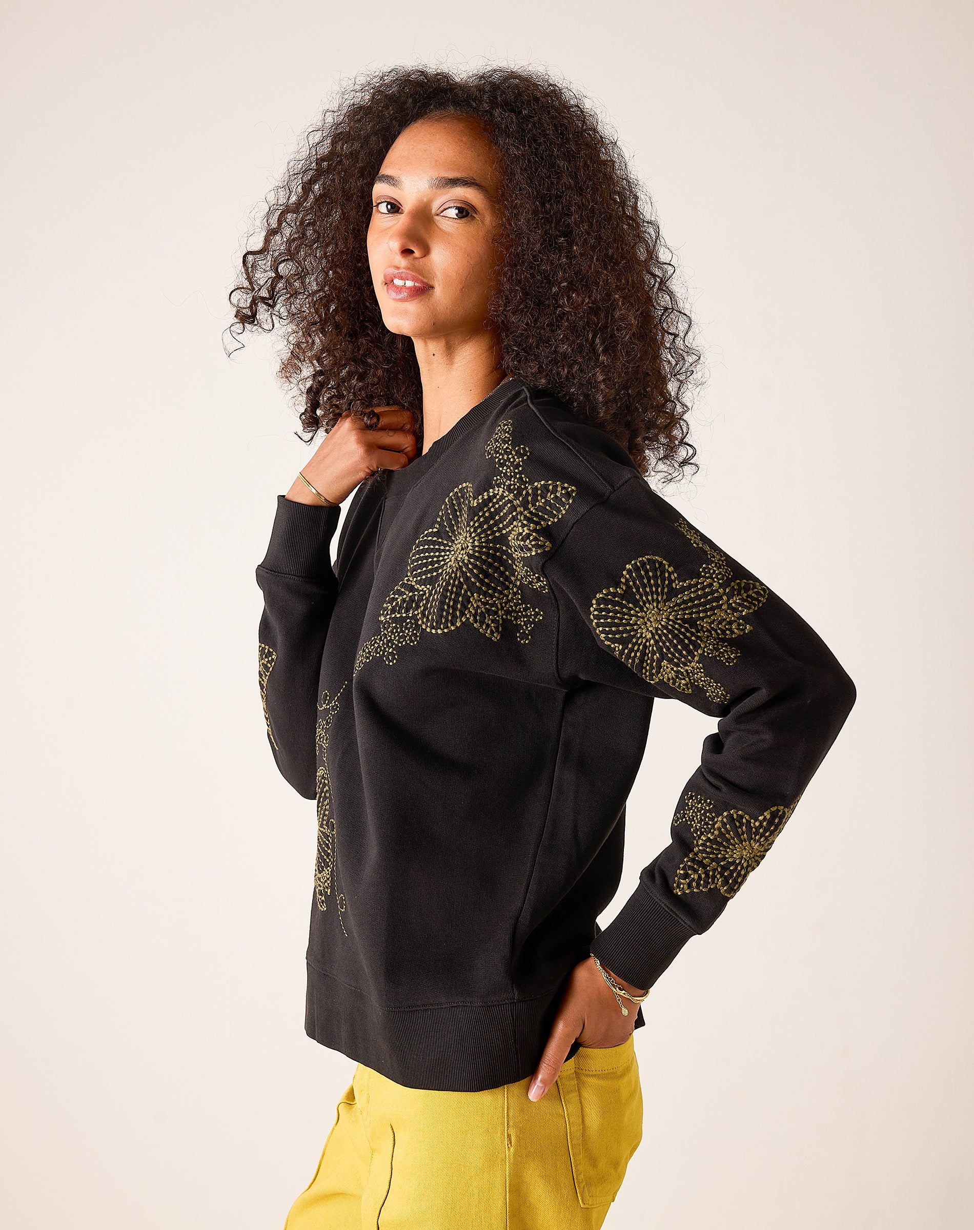 Military green oversized fit cotton blend sweatshirt featuring large gold daisy flower embroidery