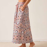 Multi-colored arched floral print maxi skirt with a high waist and ties.