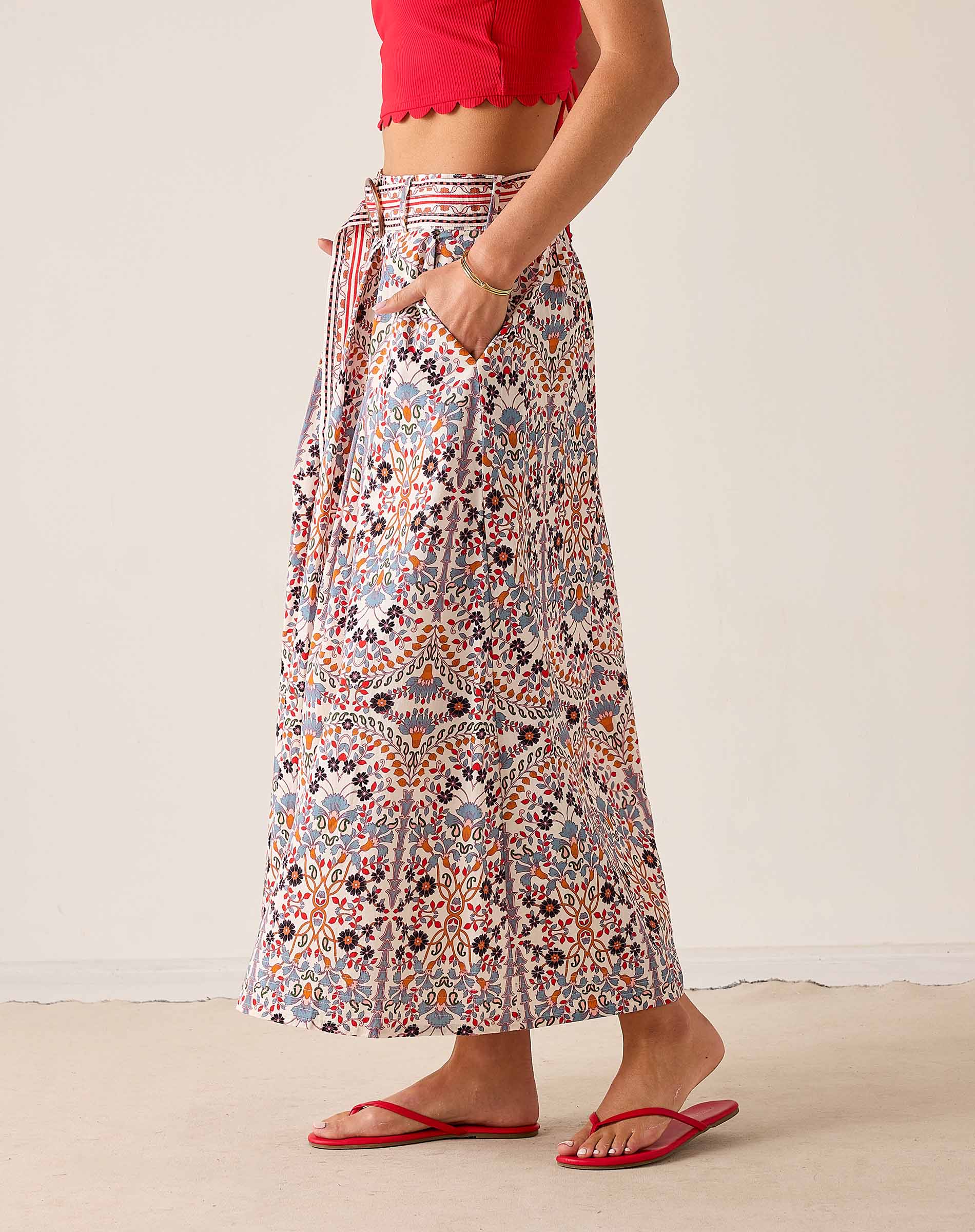Multi-colored arched floral print maxi skirt with a high waist and ties.