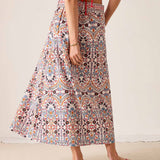 Multi-colored arched floral print maxi skirt with a high waist and wide hem.