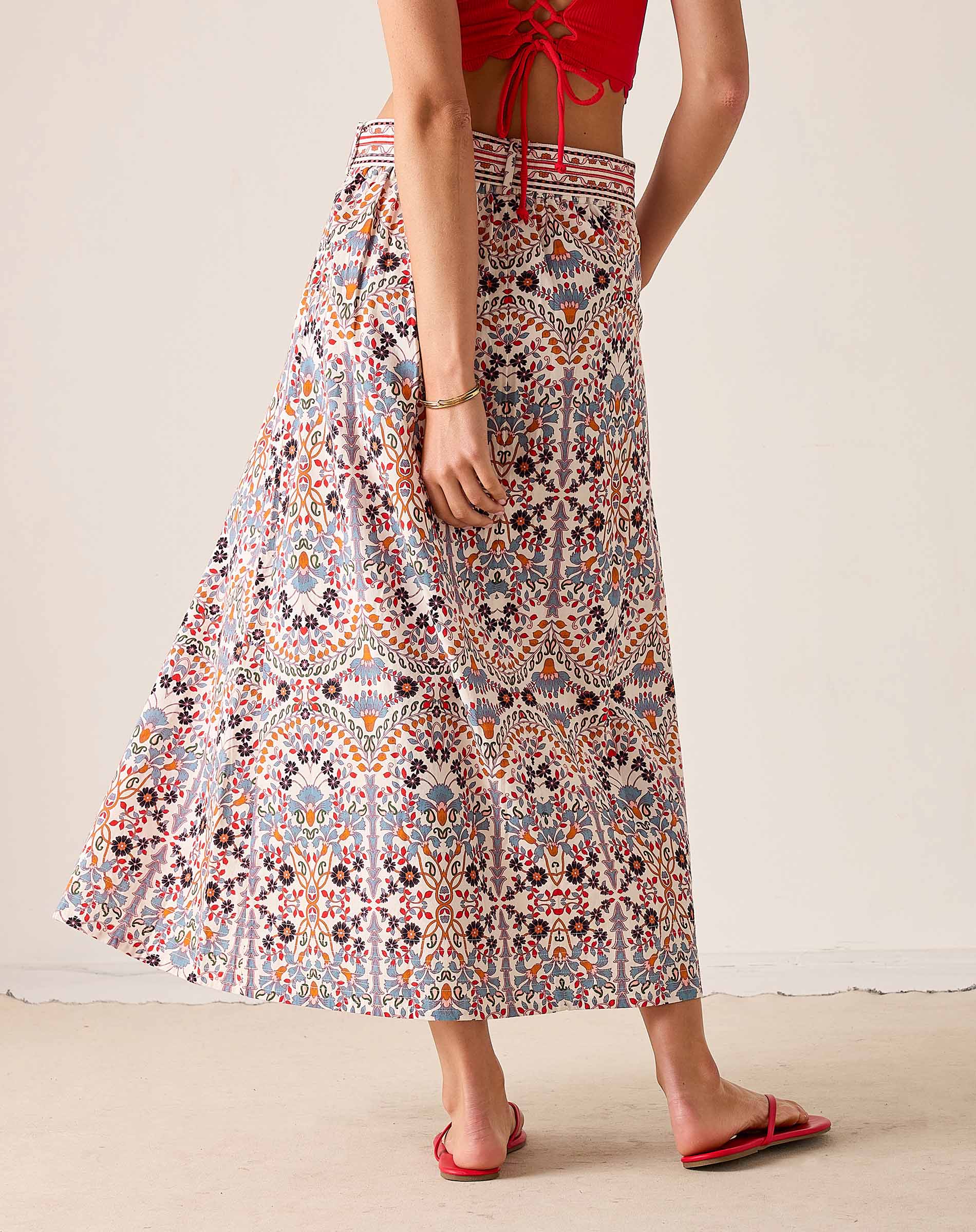 Multi-colored arched floral print maxi skirt with a high waist and wide hem.