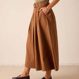 Saddle brown wide-leg skirt with a pleated front and high waistband.