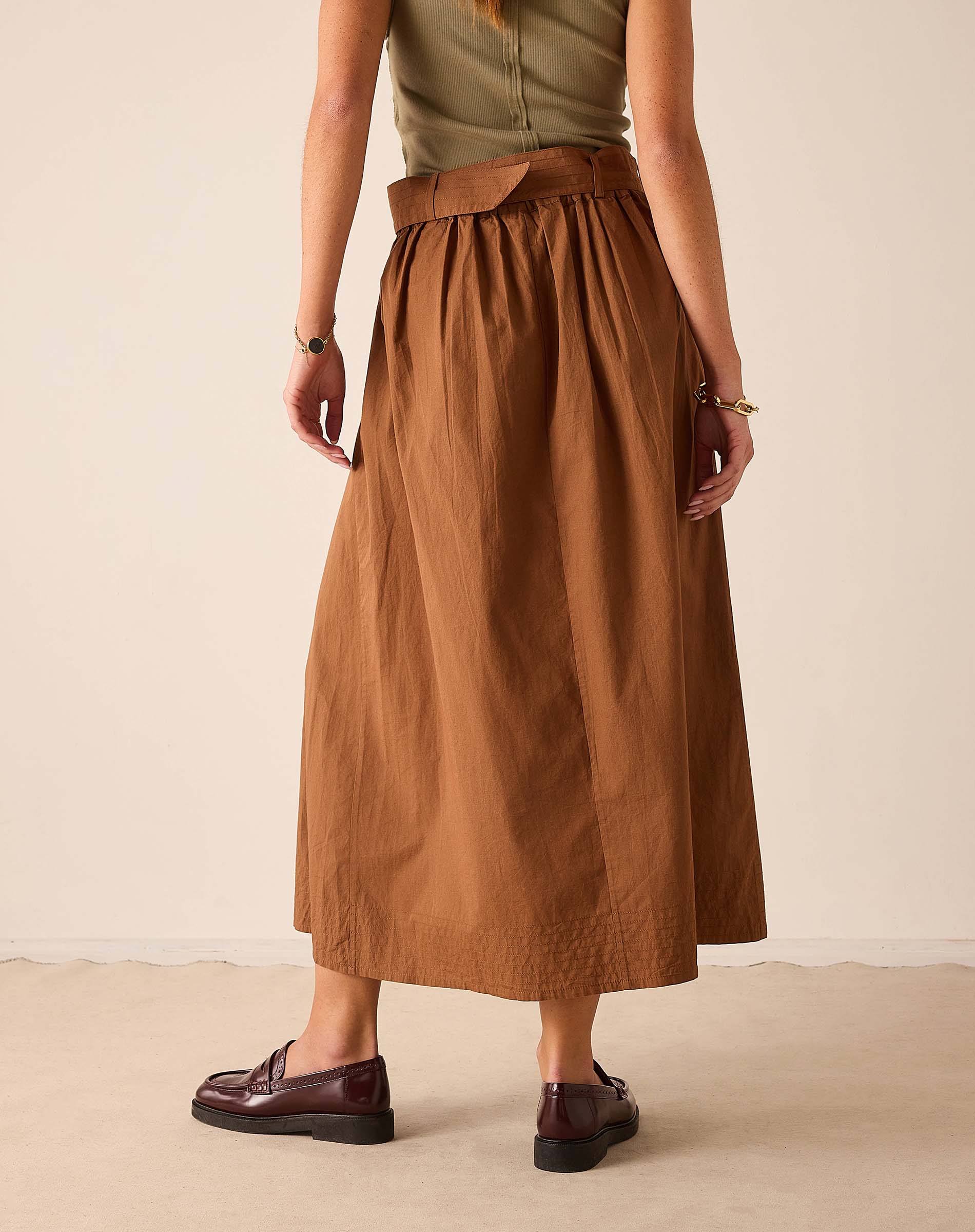 Saddle brown A-line skirt with a pleated waist and wide hem.
