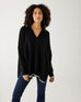 woman showcasing mersea marina polo sweater in black with sand color detail