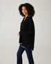 profile of woman showcasing mersea marina polo sweater in black with sand color detail