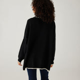 rearview of woman showcasing mersea marina polo sweater in black with sand color detail