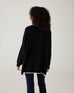 rearview of woman showcasing mersea marina polo sweater in black with sand color detail